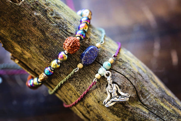 Natural gemstone beads bracelets on wooden background - Photo, Image