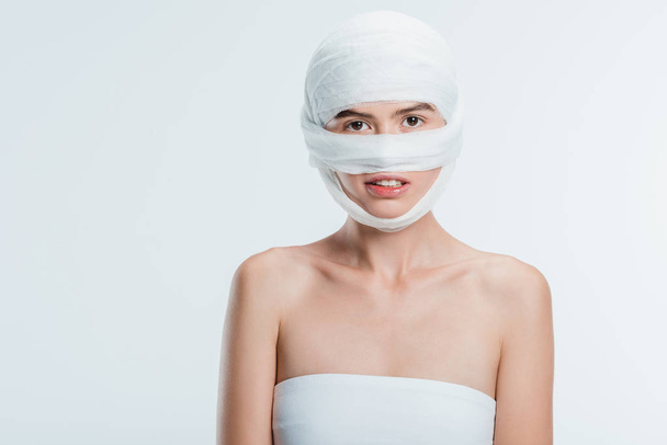mujer con vendajes sobre la cabeza aislada en blanco
 - Foto, Imagen