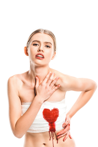 adult woman in bandages with bloody heart isolated on white - Photo, Image