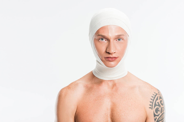 adult handsome man with bandages over head after plastic surgery isolated on white - Photo, Image