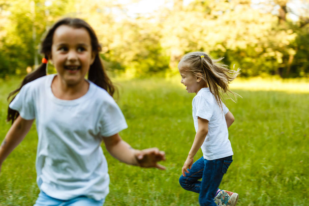 Happy children running in green summer park - Photo, Image
