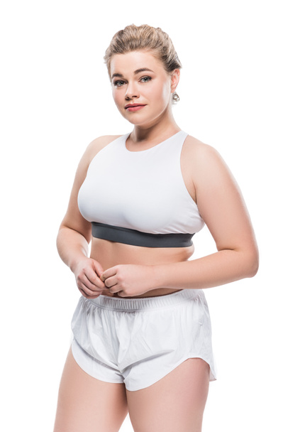 beautiful oversize girl in sportswear looking at camera isolated on white - Foto, imagen