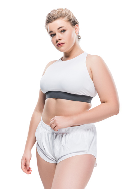 young size plus woman in sportswear looking at camera isolated on white - Fotografie, Obrázek