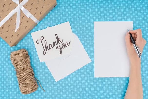 white postcard with thank you lettering and blank sheet isolated on blue background - Fotó, kép