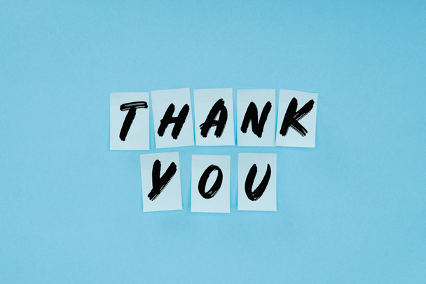 thank you wording on sticky notes isolated on blue background - Photo, Image