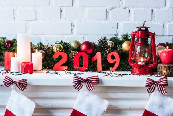 2019 year sign with Christmas wreath, candles and socks  - Photo, Image