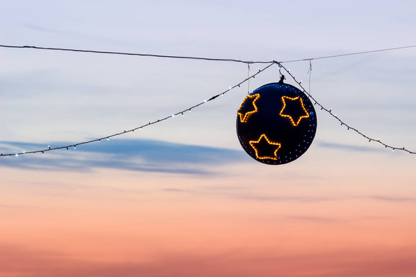 Suspended christmas street lights at sunset - Photo, Image