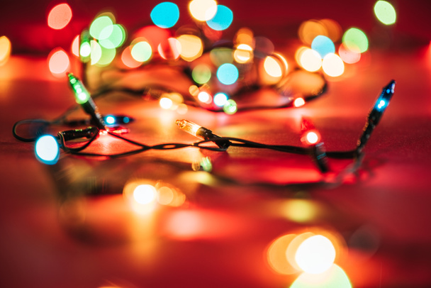 blurred shining colourful garlands as christmas background  - Photo, Image