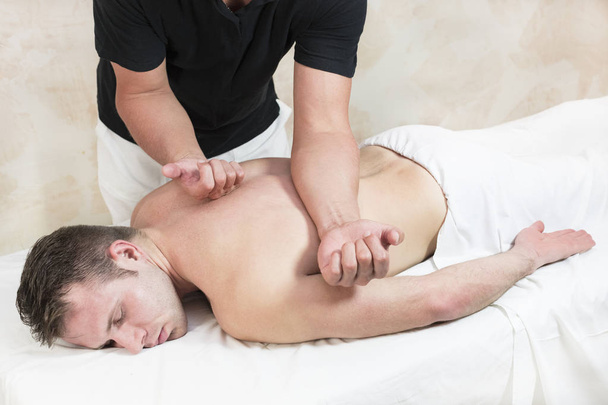 Young man on wellness treatments sports massage  - Fotografie, Obrázek