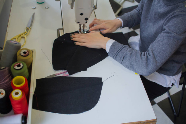 seamstress workshop , processes of tailor working at studio with clothes - Fotó, kép
