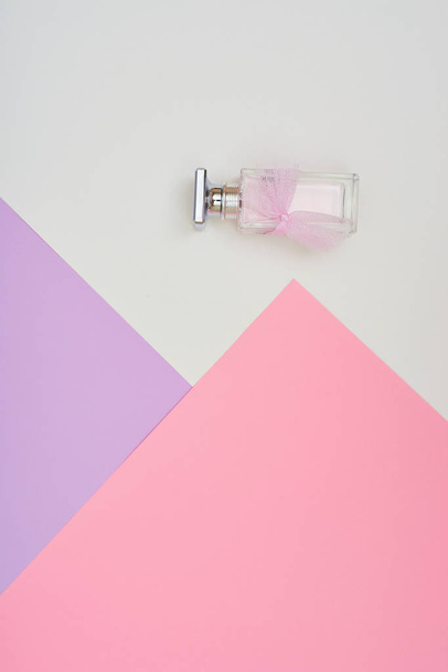 Perfume bottle on pastel background. Minimal style. - Photo, image