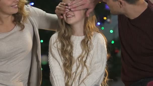 Loving parents giving daughter two big x-mas gifts, making surprise, happiness - Filmagem, Vídeo