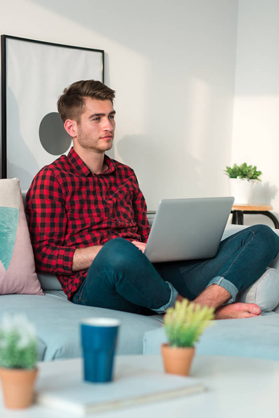 Young Businessman working at home in plaid shirt - Foto, Bild