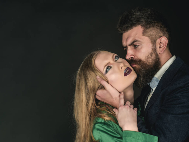 Enjoying sensual life. Couple in love. Style icons. Bearded man hug woman with long hair. Intimate couple in fashion clothing. Fashion style and hair care. They both love fashion, copy space - Fotoğraf, Görsel