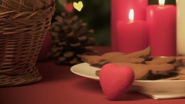 Hand put note For Santa near gingerbread cookies and toy heart, gift with love - Filmati, video