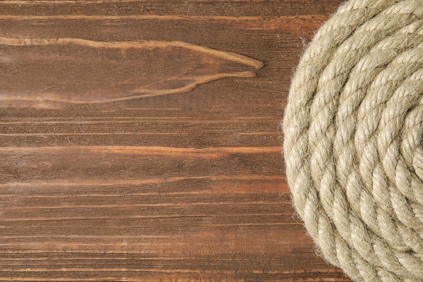 Hemp rope on wooden background, top view. Space for text - Фото, изображение