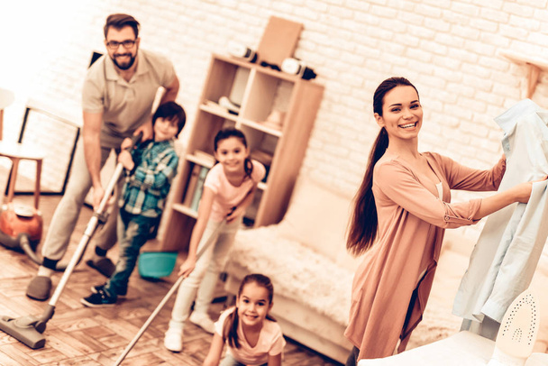Happy Cute Smiling Big Family Cleaning Room. Mother with Kids Washing at Home. Cleaning Day Concept. Kids Helping House Chores. Parent Concept. Domestic Concept. Togetherness Cleaning. - 写真・画像