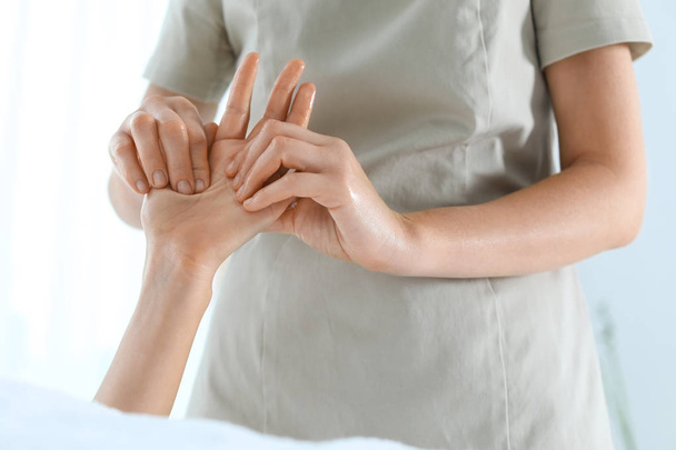 Woman receiving hand massage in wellness center, closeup - Fotó, kép
