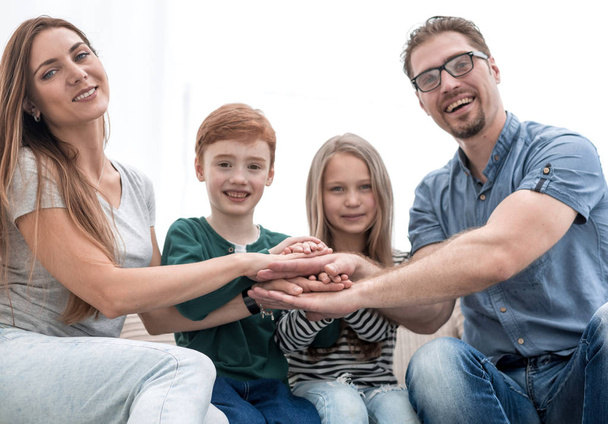 happy family making a tower out of their hands - Foto, Bild
