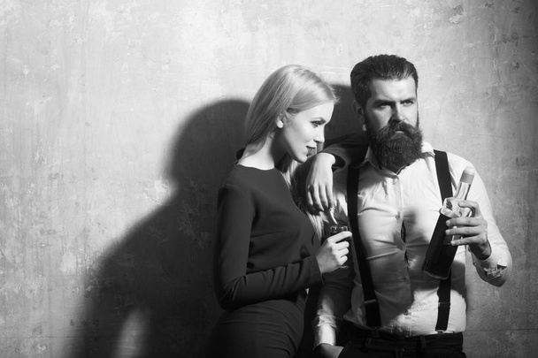 Couple in love posing with bottle and glass of liqueur - Foto, immagini