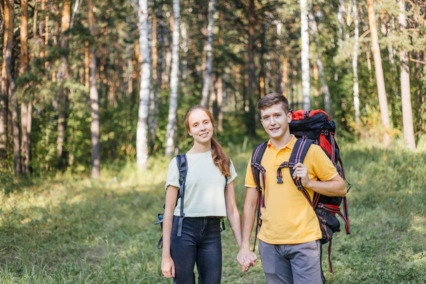 coppia di turisti con zaini che camminano in una foresta
 - Foto, immagini