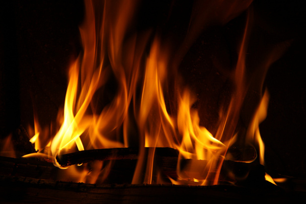 Feu dans une cheminée, flammes de feu sur un fond noir
 - Photo, image