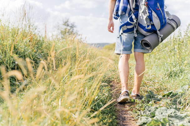 young traveler guy hiking with backpack in the nature - Photo, image