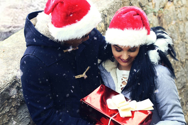 Man presenting gift to woman for christmas . Christmas concept - Фото, изображение