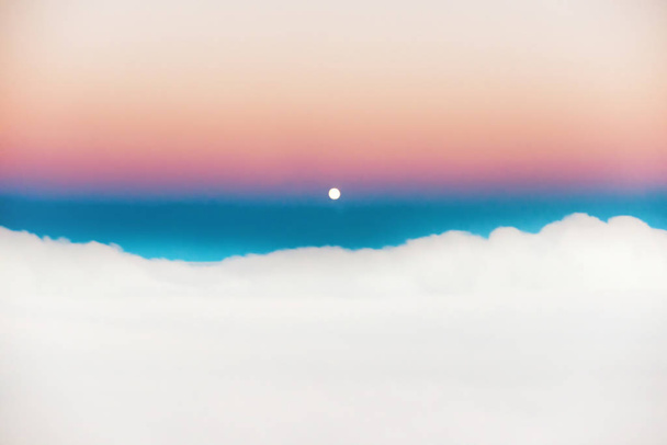 Sky and clouds at sunset with full moon rising, aerial view from plane - Foto, afbeelding
