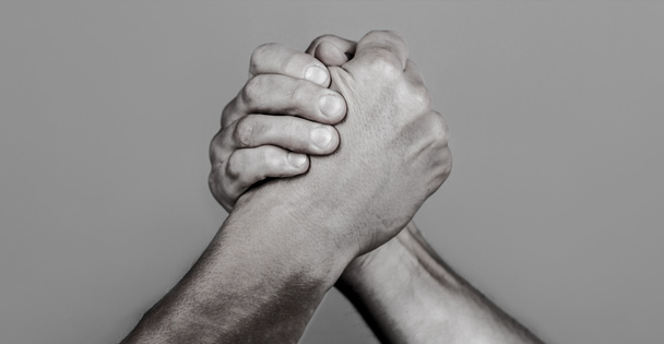 Friendly handshake, friends greeting, teamwork, friendship. Handshake, arms, friendship. Hand, rivalry, vs, challenge, strength comparison. Man hand. Two men arm wrestling. Arms wrestling. Closep up - Fotó, kép