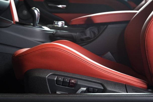 Sedile conducente in pelle rossa con cuciture all'interno interni auto di lusso
 - Foto, immagini