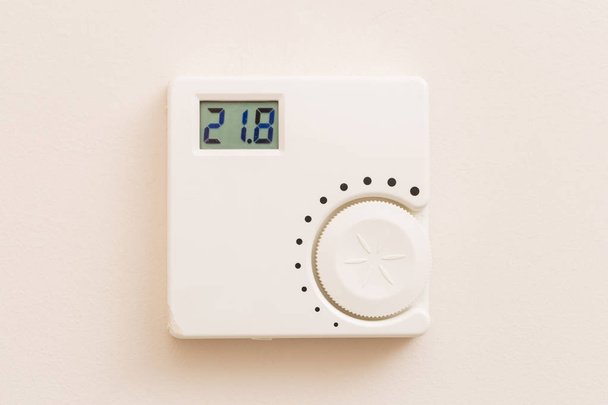 Termostato digital blanco que muestra la temperatura en la pared como concepto de control de calor
 - Foto, imagen