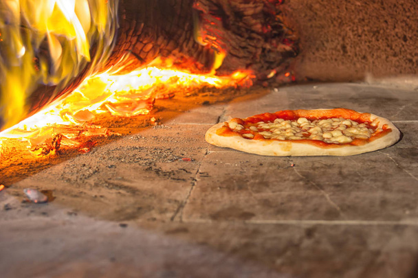 Pizza in stone oven, italian food - Fotó, kép