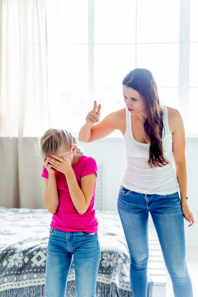 a portrait of a daughter and mother having quarrel at home - Фото, изображение