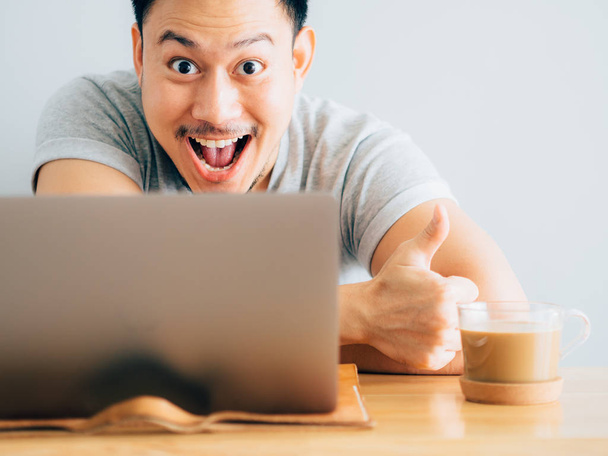 Wow face of asian man use laptop. - Фото, изображение