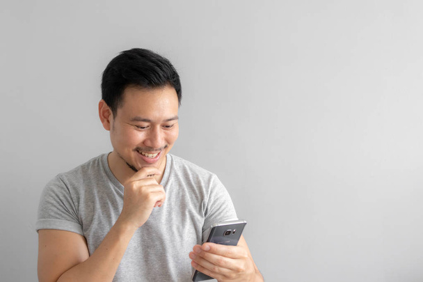 Smile and happy face of Asian man use and touch his smartphone. - Valokuva, kuva