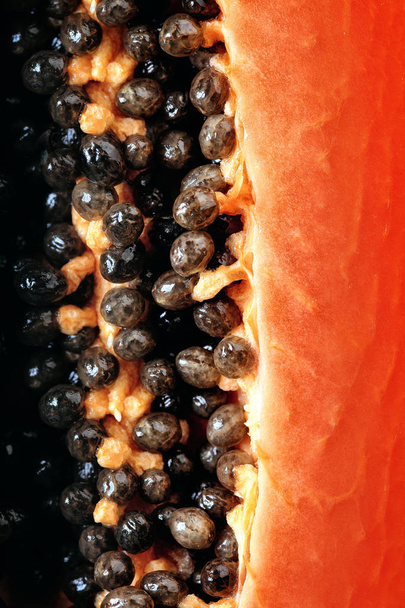 Papaya fruit (Paw Paw) half Macro image viewed from above with seeds - Foto, immagini