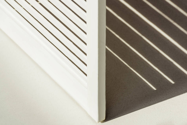 close up of wooden white room divider against daylight with shadow - Fotó, kép