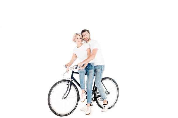 Fantastic couple hugging while riding bicycle together isolated on white - Photo, Image