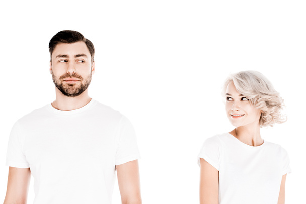 Wonderful couple in white t-shirts looking at each other isolated on white - Fotó, kép