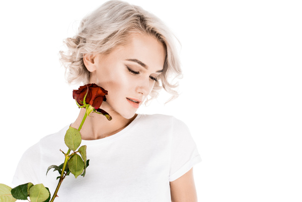 Attractive  woman holding red flower isolated on white - Zdjęcie, obraz