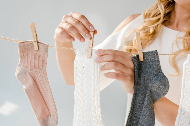 primo piano di donna mettere calzini su clothesline con mollette
 - Foto, immagini