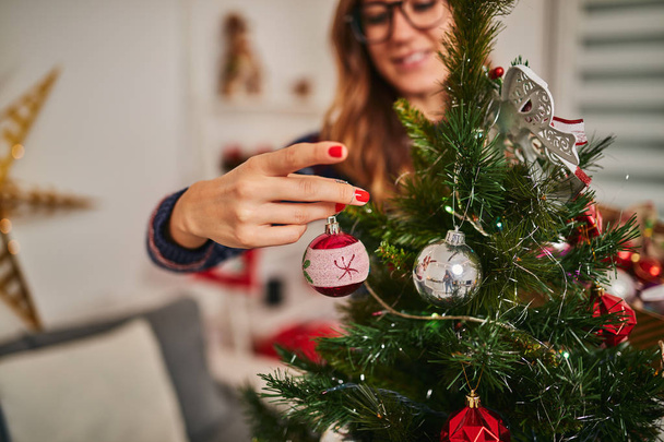 Woman preparing shiny decoration for Christmas / New Year's eve. - Foto, Imagem