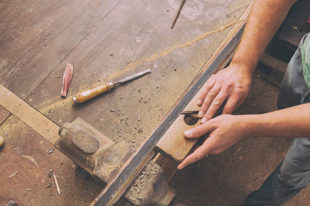 Carpenter working on the wood in his shop. - Fotografie, Obrázek