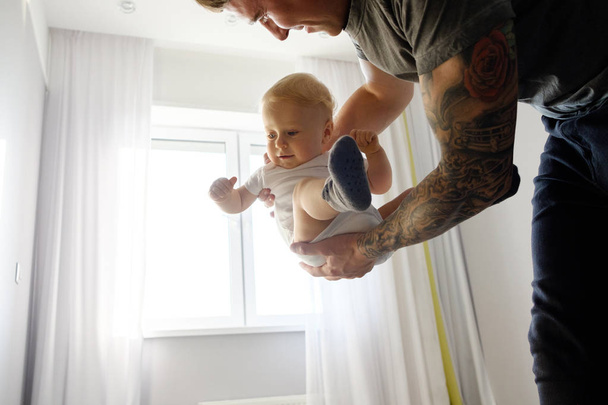 Father plays with the child at home. A happy family. Bright hues - Foto, afbeelding