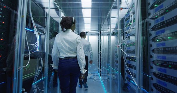 Two employees performing maintenance in a data center - Photo, Image