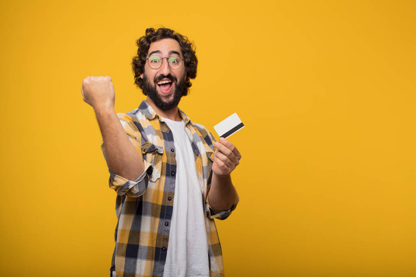 young crazy mad man in fool pose with a credit card. Cash or money concept. - Fotoğraf, Görsel