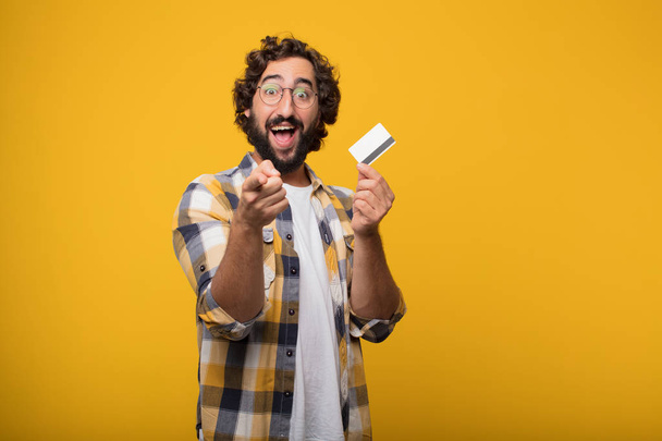 young crazy mad man in fool pose with a credit card. Cash or money concept. - Φωτογραφία, εικόνα