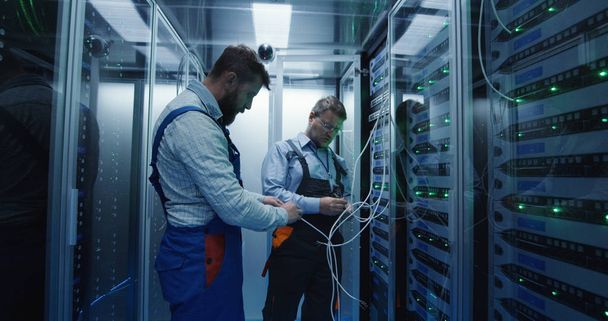 Two men working in a data center - Photo, Image