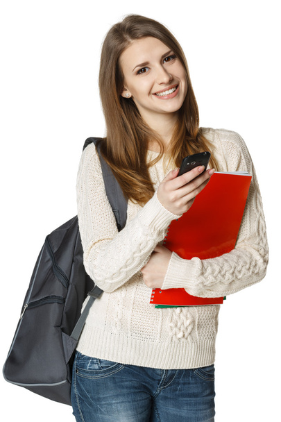student with backpack and books sending a sms on cell phone - Zdjęcie, obraz